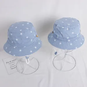 Light blue baby sun hat with white star pattern and adjustable chin strap