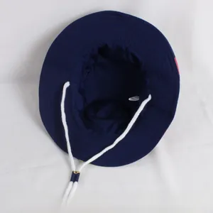 Detail view of navy blue kids bucket hat interior with chin strap and wash label