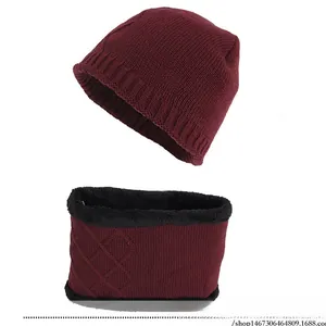 Detail of burgundy knitted hat and neck warmer set with warm fleece lining and embroidery