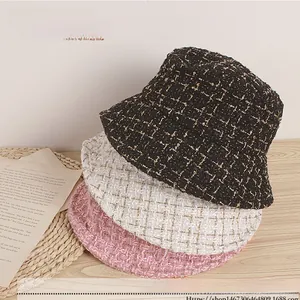 Close-up of kids tweed bucket hats in black, beige and pink with metallic silver thread