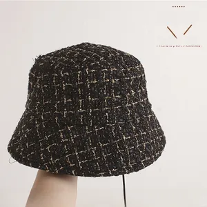 Detail of tweed bucket hat with gold thread texture and classic checkered weave
