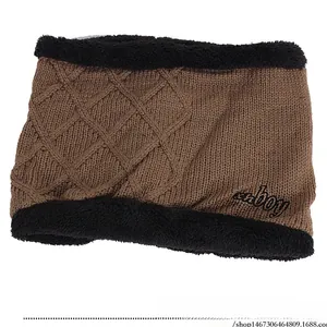 Detail of knitted winter neck warmer with thick faux fur lining and xn-boy embroidery
