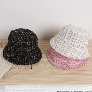 Detailed close-up of tweed children bucket hats in black white and pink with metallic yarn