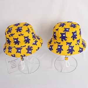 Yellow kids bucket hat with purple bear print and white adjustable chin strap