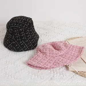 Detail of tweed bucket hats for children with glittery thread and textured weave