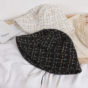 Detailed close-up of tweed fisherman hats with metallic threads and woven texture