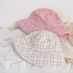Detail of pink and cream tweed kids bucket hats with shimmering gold metallic thread