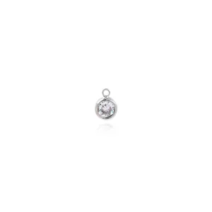 Macro detail of a minimalist 18K silver-plated pendant featuring a brilliant round zircon