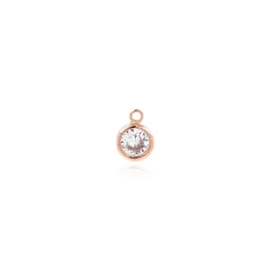 Macro view of 18K gold-plated round pendant featuring a sparkling bezel-set zircon stone