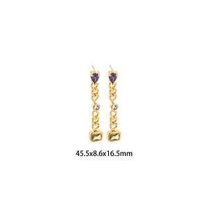 Detail view of 18K gold-plated drop earrings with heart crystal and rectangular stones