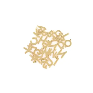 Macro shot of 18K gold-plated 26-letter connectors for DIY necklace jewelry making