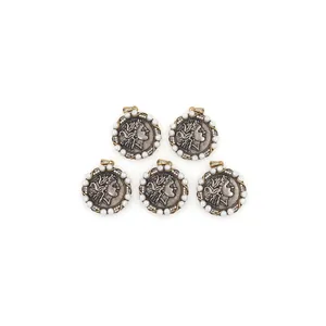 Detailed view of 18K gold plated coin pendants with pearl halo and classic relief