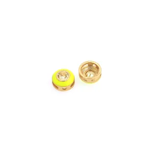 Macro shot of 18K gold plated bead connector with neon yellow enamel and zircon stone