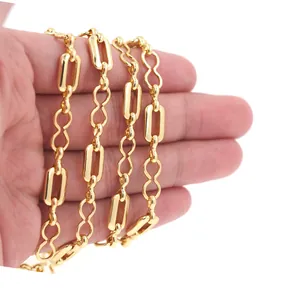 Close-up of 18K gold-plated rectangle link chain held in hand for DIY jewelry making