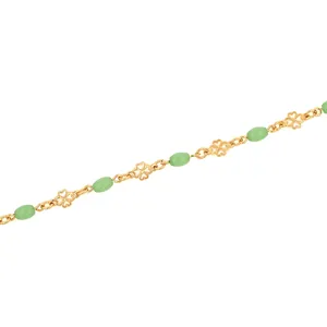 Detailed macro view of 18K gold-plated clover chain with translucent green beads