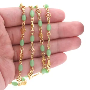 Macro detail of 18K gold-plated clover chain with light green beads for DIY jewelry making