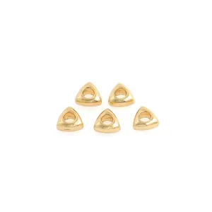 Macro shot of 18K gold-plated triangular spacer beads with a smooth polished finish