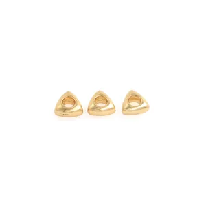 Detailed view of three 18K gold-plated triangle beads with smooth edges for DIY jewelry