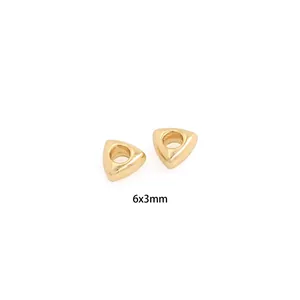 Macro shot of 6x3mm gold-plated triangle spacer beads for DIY jewelry making