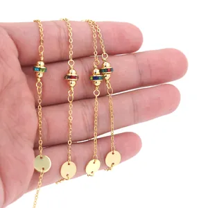 Detail of 18K gold plated bead chains with colorful zircon accents and round pendants
