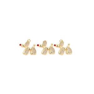 Detailed view of three 18K gold plated poodle pendants with cubic zirconia inlay