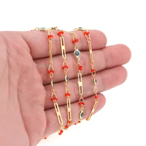 Detail of 18K gold-plated necklace chain with red beads and blue crystals for DIY jewelry