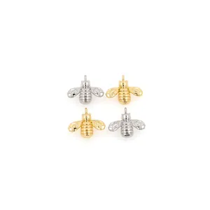 Detailed view of 18K gold and silver plated bee pendants with cubic zirconia accents