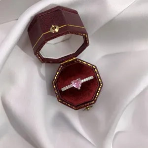 Close-up of a S925 sterling silver heart-shaped pink zircon ring in a velvet gift box