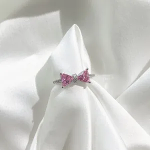 Close-up of S925 silver ring featuring pink heart stones in a bowknot design with zircon