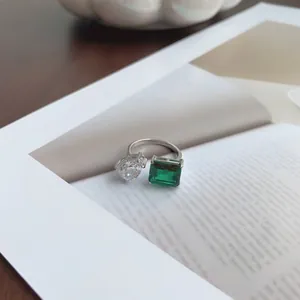 Detailed view of S925 silver ring featuring pear-cut and emerald-cut green zircons