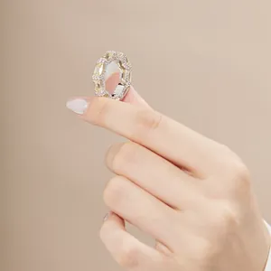 Macro shot of silver ring with yellow rectangle gemstone and pavé diamonds details