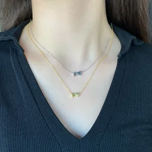 Close-up of S925 silver layered necklaces with F-letter heart pendants in gold and silver