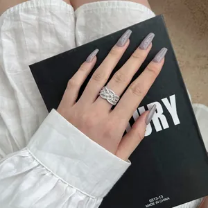 Détail d'une bague large en argent S925 sertie de zircons ronds et baguettes
