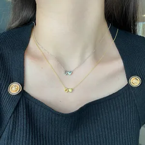 Close-up of S925 sterling silver heart and letter Q pendant necklaces in gold and silver
