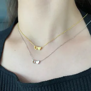 Detail shot of S925 silver heart necklace with letter U pendant in gold and silver finish