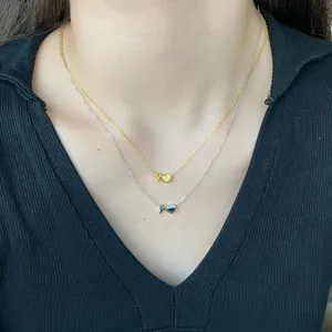 Close-up of layered S925 silver heart necklaces with Y-letter pendants on model