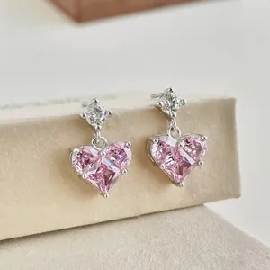 Detail of S925 silver heart stud earrings featuring pink zircon and white accent stones
