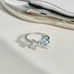 Macro detail of S925 silver ring with blue heart stone and zircon bow design