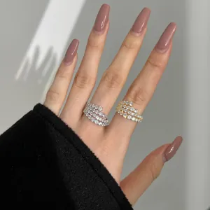 Detail of s925 silver and gold spiral multi-layer rings with cubic zirconia pavé