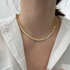 Close-up of double-layer maple leaf necklace with gold beads and sparkling zircon stones