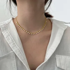 Detail of 18K gold plated silver necklace with cubic zirconia beads on a model