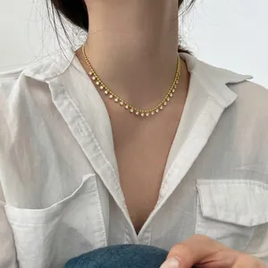 Close-up of 18K gold plated silver necklace with sparkling cubic zirconia charms