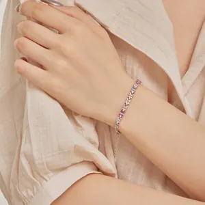 Bracciale in argento S925 con zirconi colorati a forma di fiori indossato da una donna