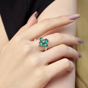 S925 sterling silver ring with clover design and green zircon gemstones on finger