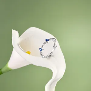 Macro detail of S925 silver flower ring with turquoise and zircon on lily petal