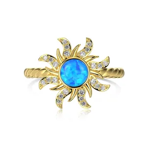 Golden twist ring with blue opal sunflower design and white zircon accents