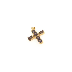 Macro shot of 18K gold plated cross pendant with purple oval gems and micro-set cubic zirconia