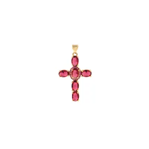 Macro detail of 18K gold-plated cross pendant with oval pink stones and micro-zirconia