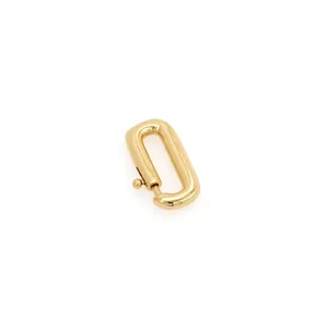 Macro detail of 18K gold plated carabiner connector with spring-loaded oval clasp mechanism