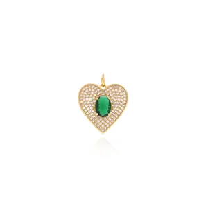 Macro shot of 18K gold plated heart pendant with green gemstone and pavé zirconia